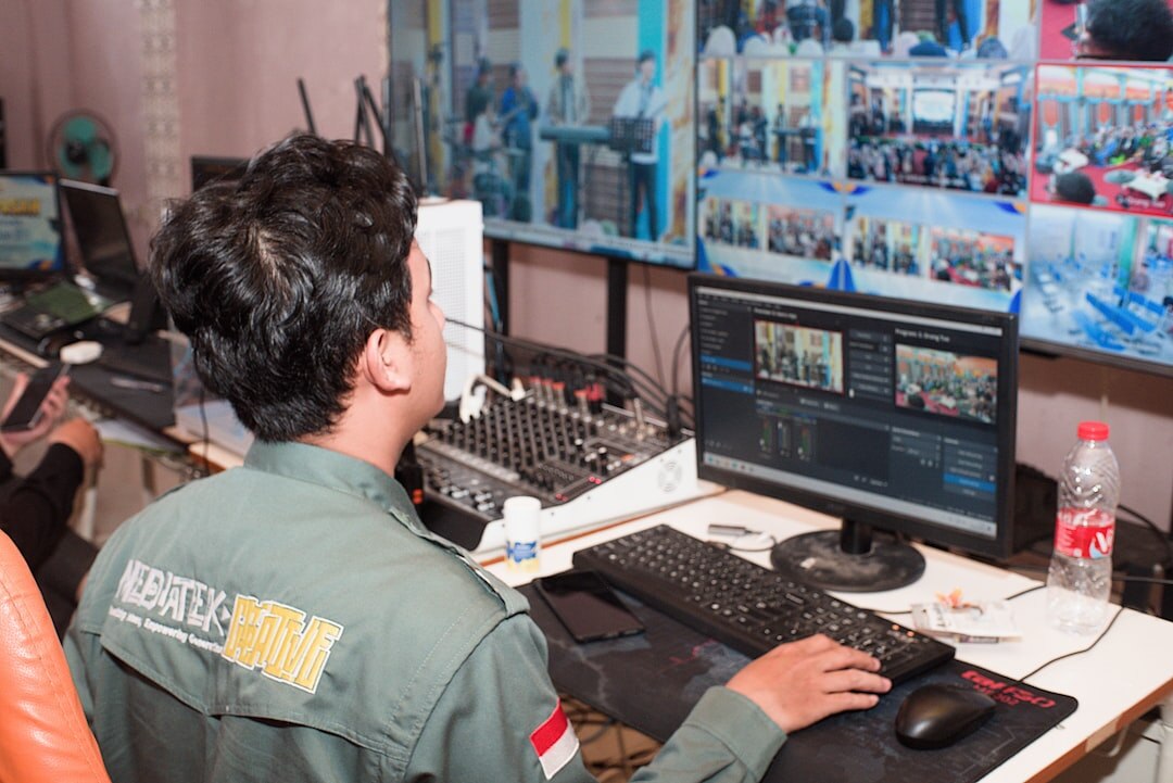 Live broadcast director monitoring multiple screens in control room